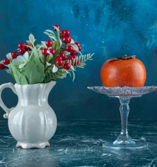 Tasty persimmon and a vase